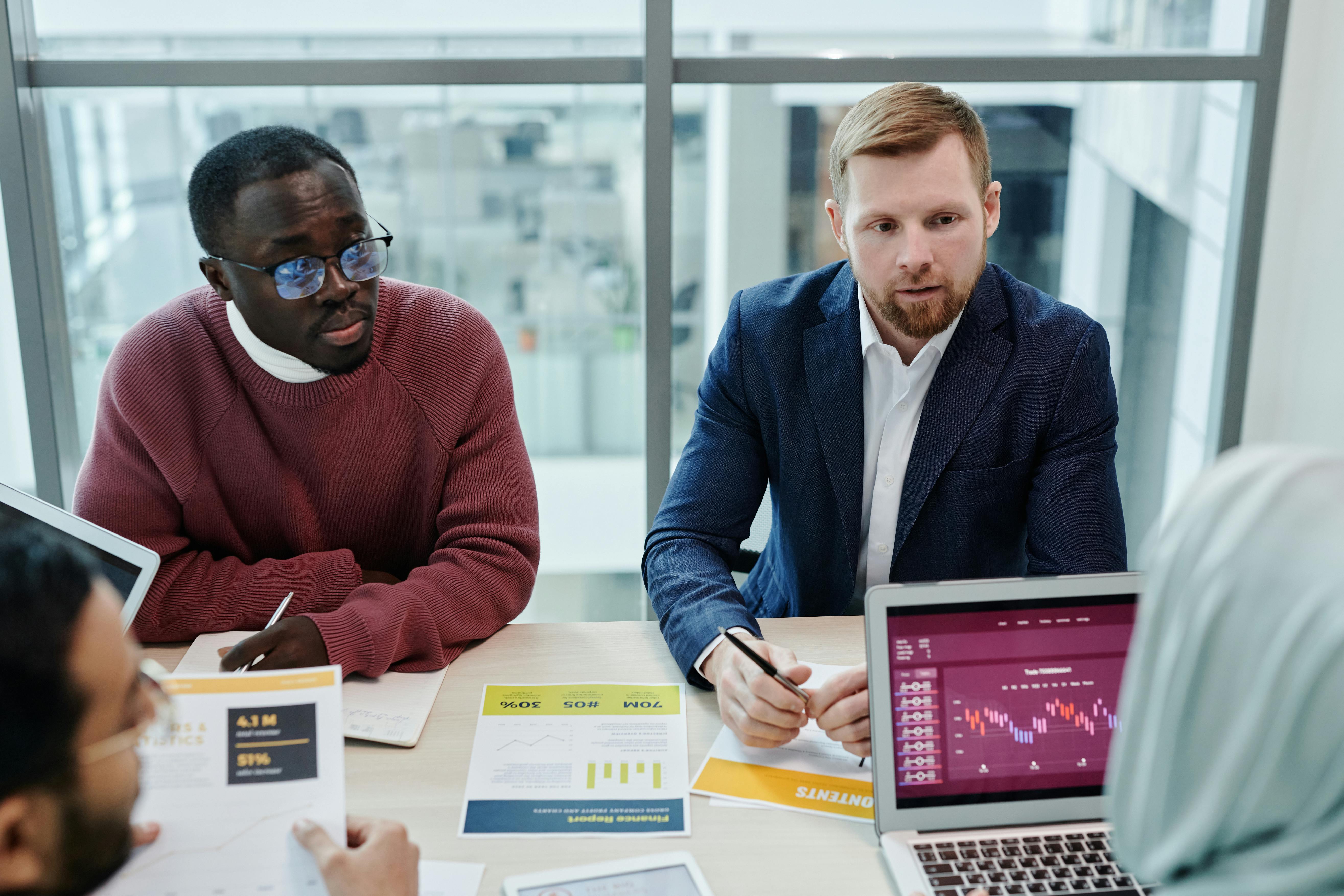 Free Man in Red Sweater Sitting beside Man in Blue Blazer Stock Photo